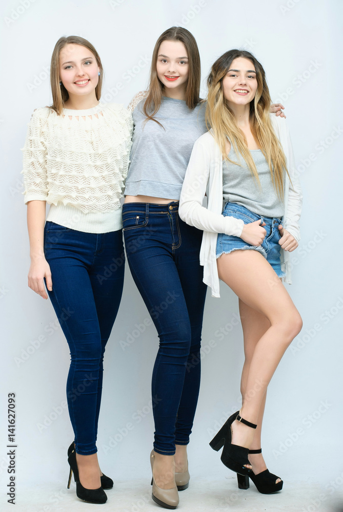Three stylish sexy hipster girls best  together and having  fun. Looking at camera. Over gray background. Stock Photo | Adobe Stock