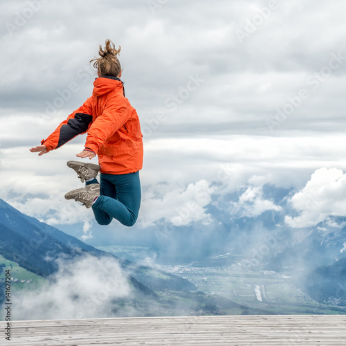 young woman on top of the mountain