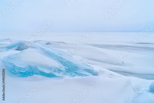 Blue frozen water covered with snow at Baikal lake during winter © pakorn482137