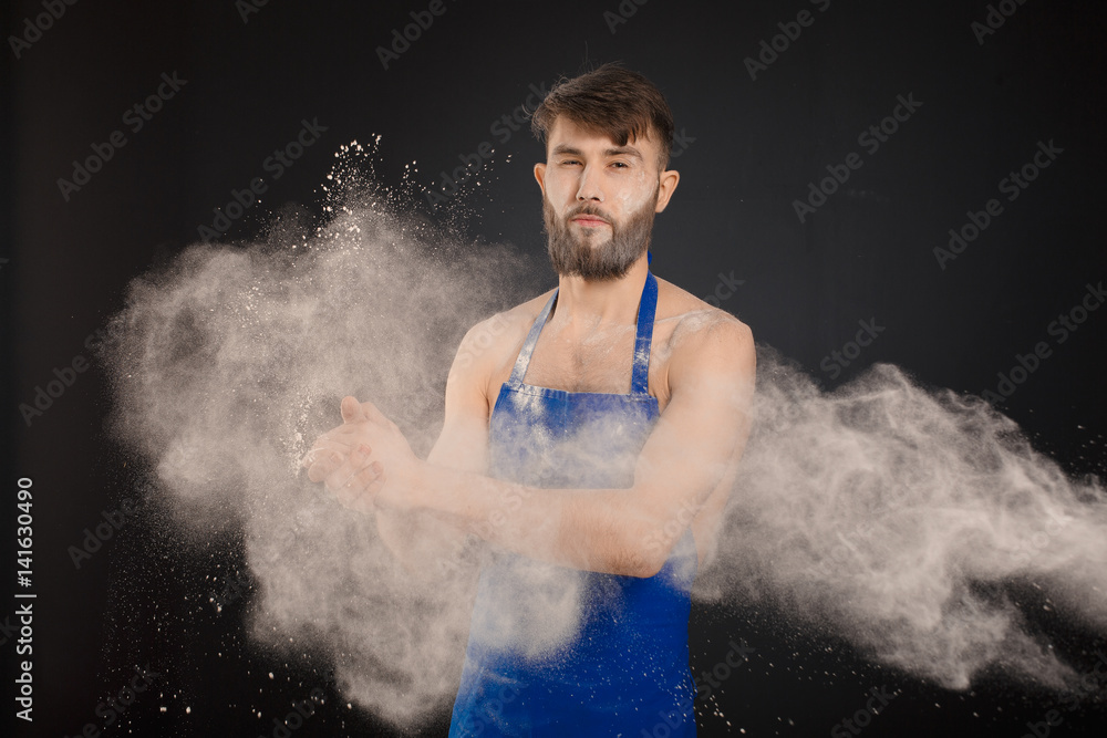 Young handyman or builder standing in the drive through in a hardware warehouse with a tablet in his hand looking at the camera