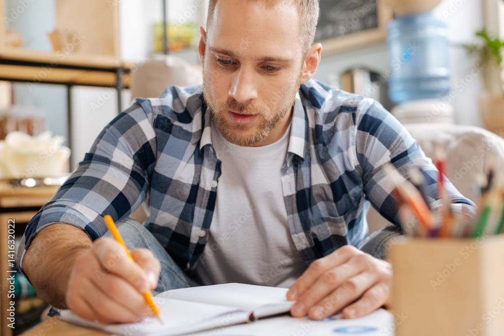Handsome creative man taking notes Handsome creative man taking notes