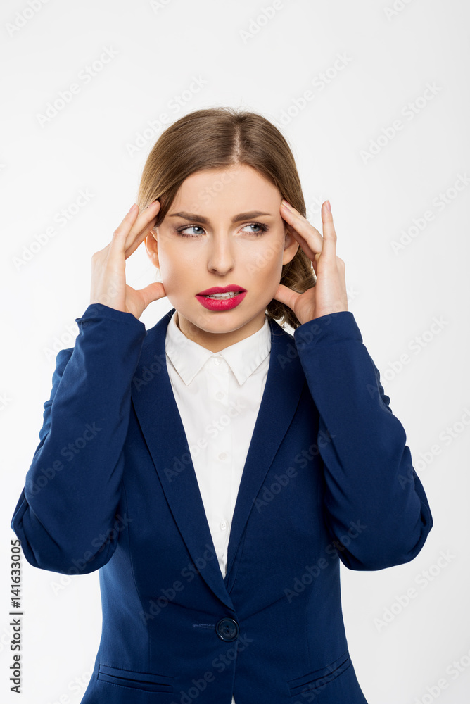 Young business woman working at office in stress suffering intense headache Young business woman working at office in stress suffering intense headache