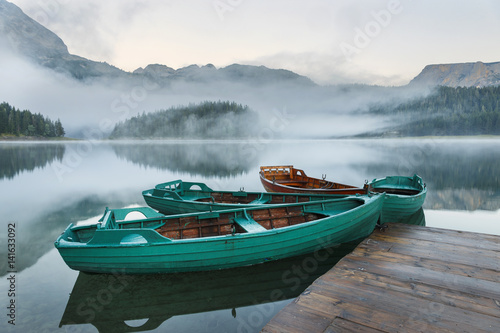 Landscape with mountains, lake and boat