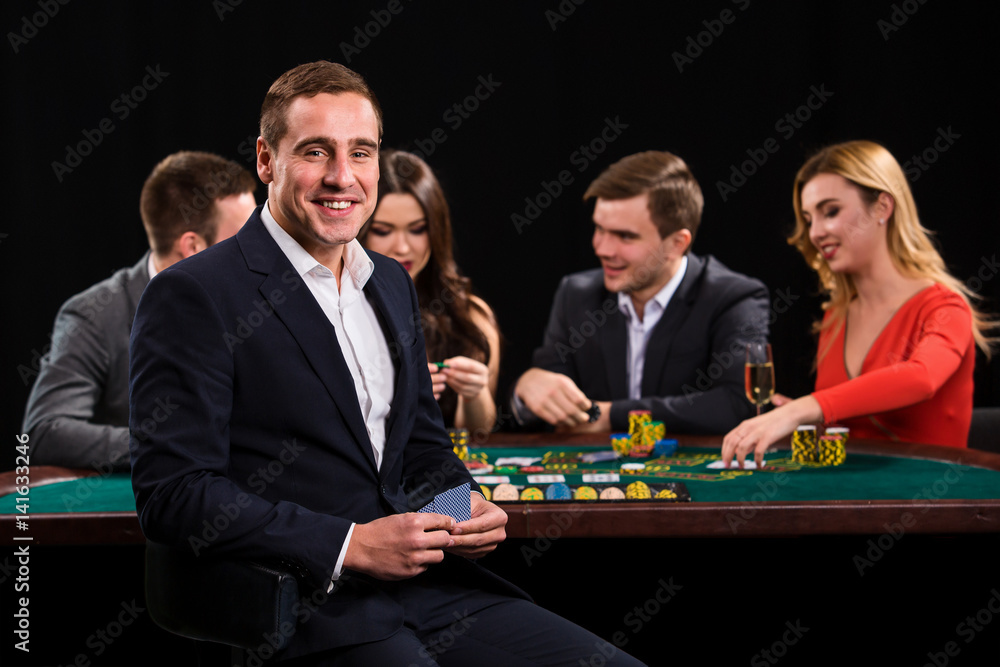 Young people playing poker at the table. Casino Young people playing poker at the table. Casino