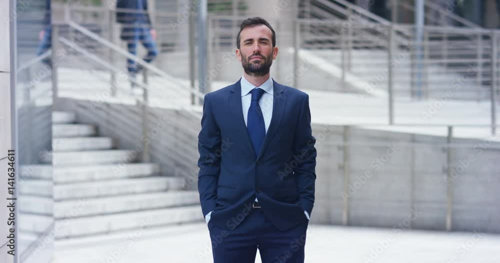 A man in a suit, looks in camera and smiles proud and sure of himself. Concept of politics, business, finance, banking, insurance and testimonials for political campaign. A man in a suit, looks in camera and smiles proud and sure of himself. Concept of politics, business, finance, banking, insurance and testimonials for political campaign.