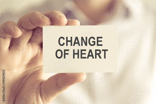 Businessman holding CHANGE OF HEART message card
