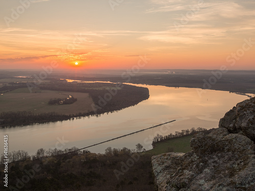 Фотография The sun rising lighting up the river valley on an early spring morning with calm