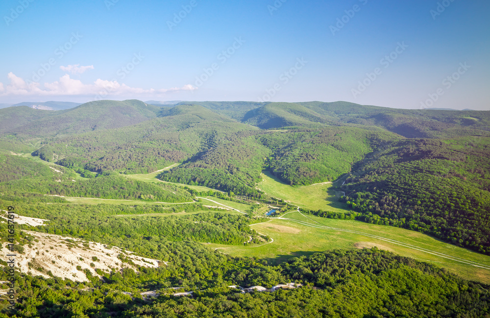 Beautiful mountain landscape with blue sky and green fields