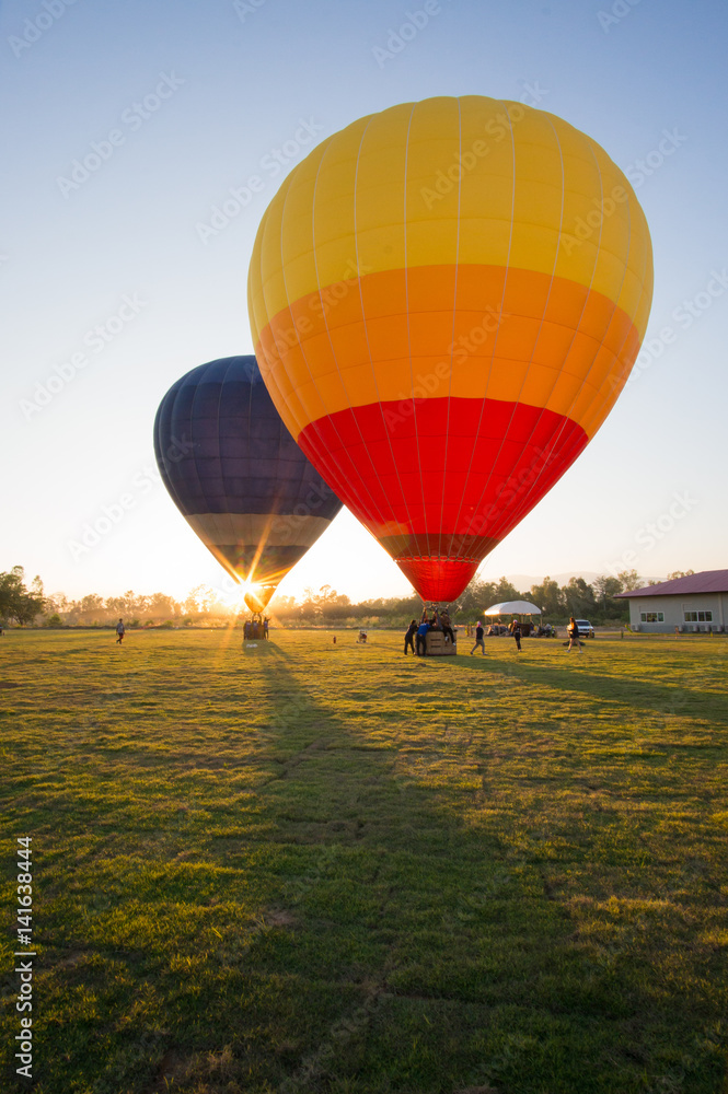 Obraz premium Two big balloon ready to take off at green field