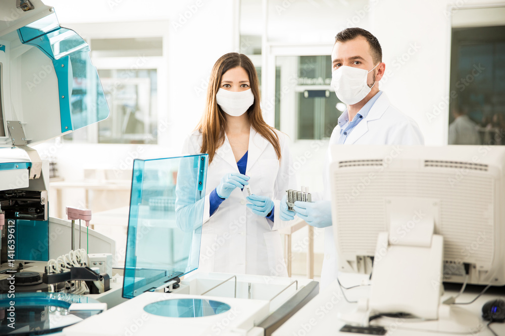 Portrait of two chemists at work in a lab