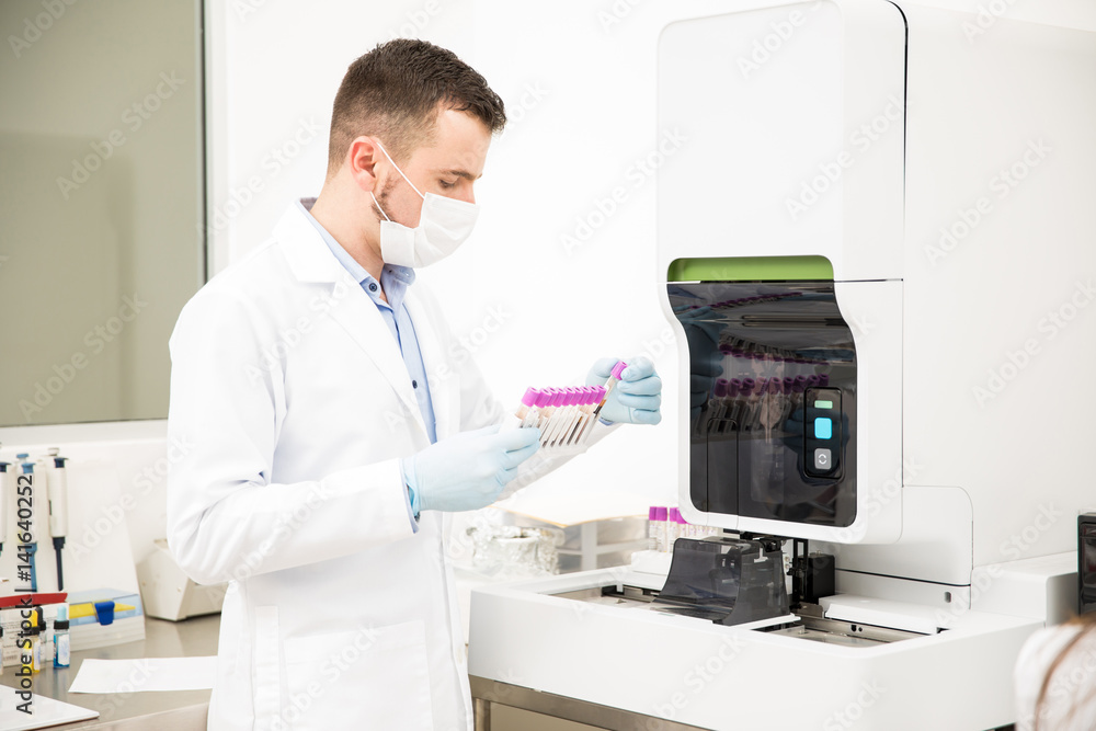 Chemist checking test tubes at a lab Chemist checking test tubes at a lab