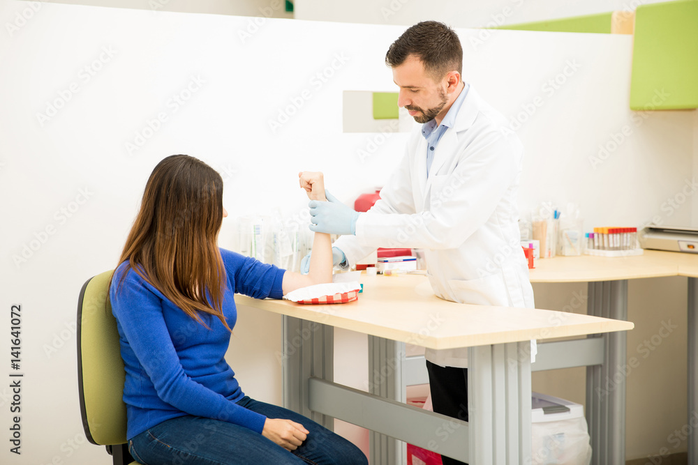 Doctor finishing blood test with a patient Doctor finishing blood test with a patient