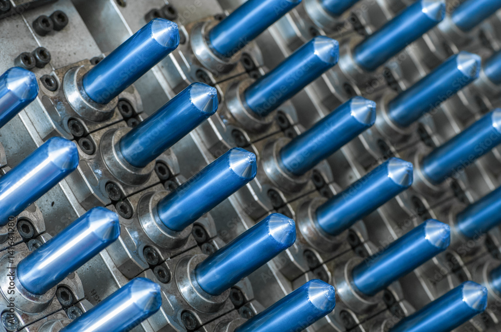 equipment for the manufacture of preforms for plastic bottles. PET production. close-up of a flask for plastic bottles equipment for the manufacture of preforms for plastic bottles. PET production. close-up of a flask for plastic bottles