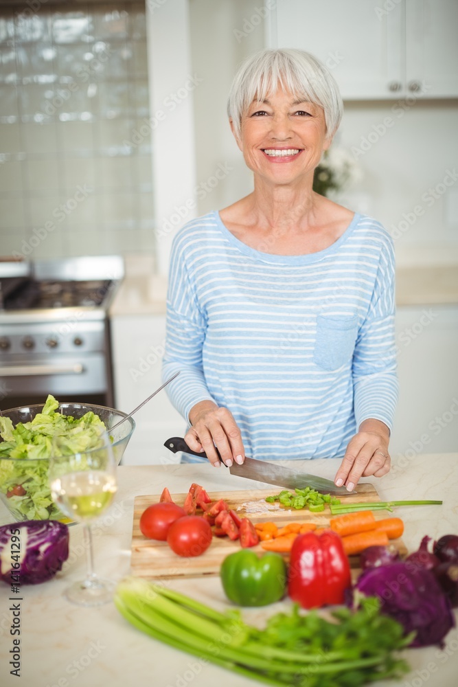 Senior woman cutting vegetable 