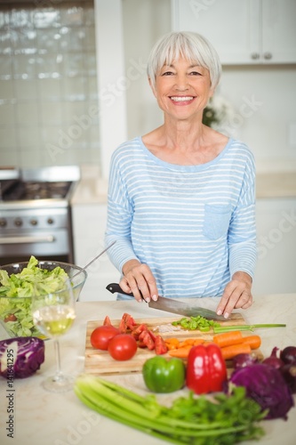Senior woman cutting vegetable 