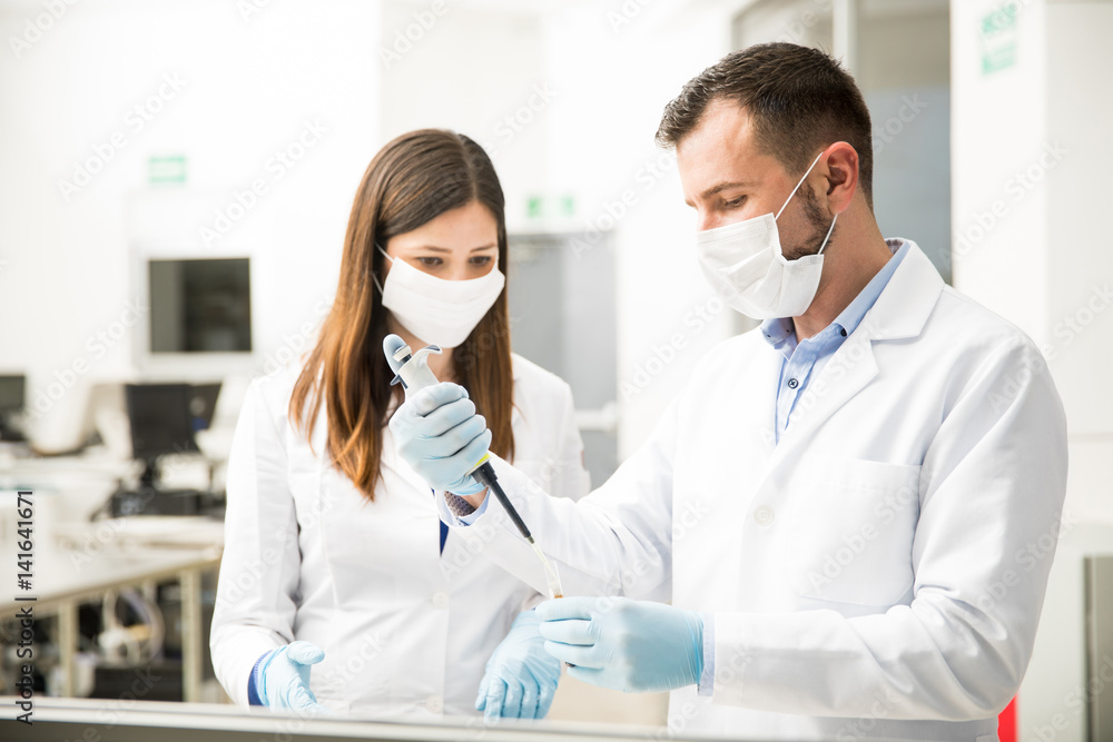 Team of scientists doing some work in a lab Team of scientists doing some work in a lab