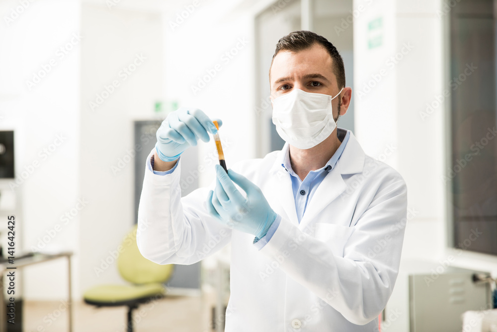 Hispanic chemist doing some work in a lab Hispanic chemist doing some work in a lab