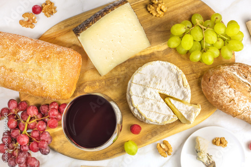 Red wine, cheese, bread and grapes at tasting