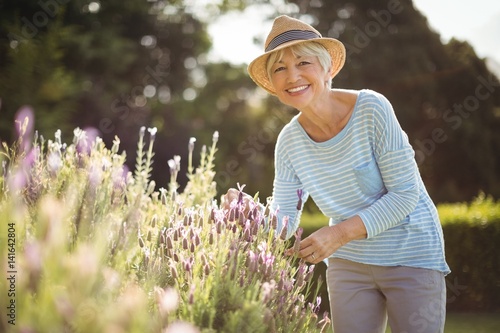 Happy senior woman standing in backyard