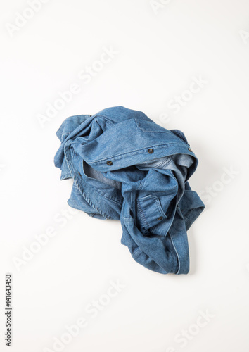 thrown blue denim jean shirt on white background