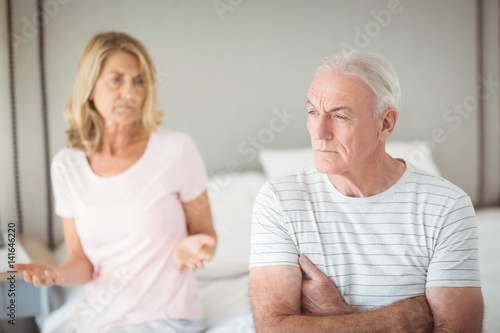 Worried senior man sitting on bed