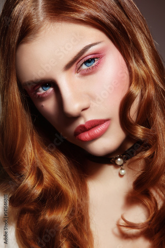 Portrait of young beautiful woman with long curly hair