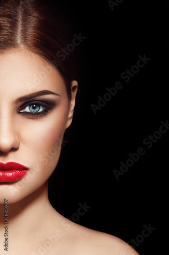 Face of young beautiful woman with smoky eyes and red lipstick  copy space