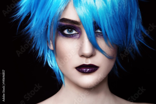 Close-up portrait of yound beautiful woman in blue cosplay wig