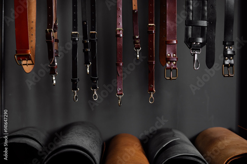 leather straps on the rack near the wall