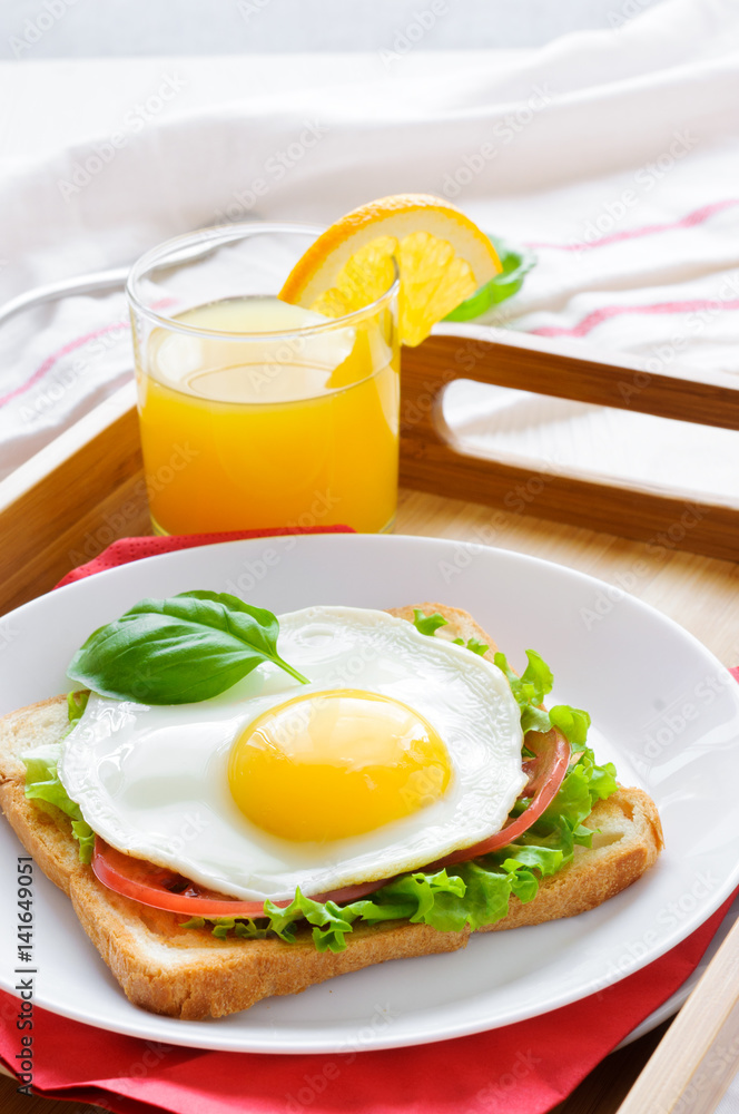 Toast with fried egg, and orange juice Toast with fried egg, and orange juice