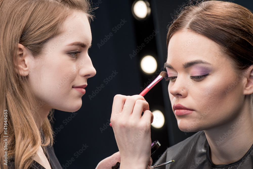 Make-up artist applying eyeshadow Make-up artist applying eyeshadow