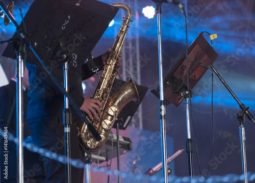 Photography Outdoor concert / View of musician blowing saxophone in outdoor concert at night