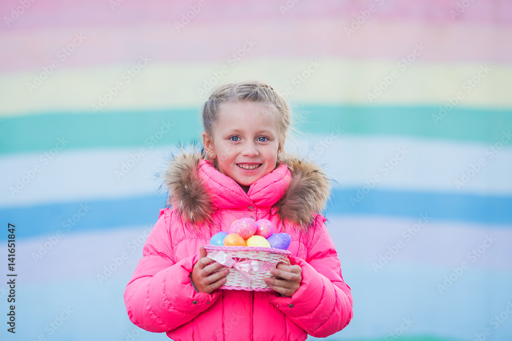 cute funny girl with colored eggs in the basket for Easter cute funny girl with colored eggs in the basket for Easter