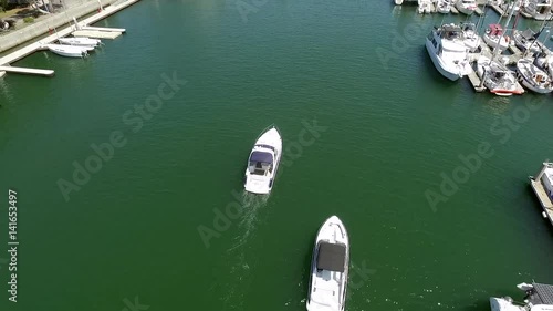 Panoramic fly over Long Beach marina and harbor with speed boats, yachts and sky jets