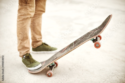 Close-up of skateboarders foot while skating in skate park