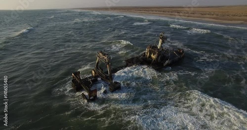 4K aerial drone video view of Namibian Atlantic coastline, Zeila L-758  Walvis Bay shipwreck and sand beach, Skeleton Coast Park landscape with ocean background at Namibia's west coast