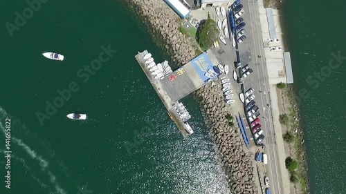 Panoramic fly over Long Beach marina and harbor with speed boats, yachts and sky jets