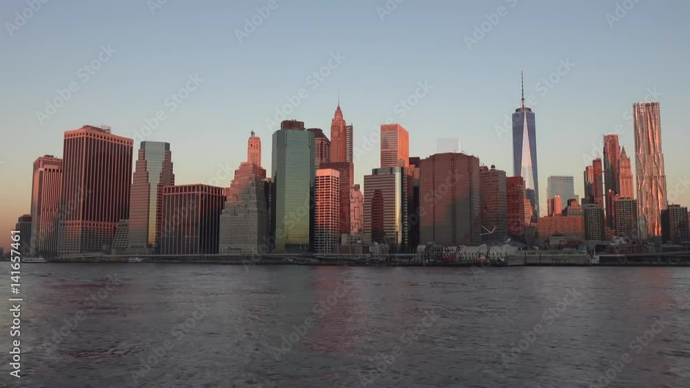 Golden sunset Manhattan Downtown panorama skyscrapers, New York City NYC Skyline. Apartments Buildings. The skyline of New York City at Sunset filmed from the the New Jersey. Golden sunset Manhattan Downtown panorama skyscrapers, New York City NYC Skyline. Apartments Buildings. The skyline of New York City at Sunset filmed from the the New Jersey.