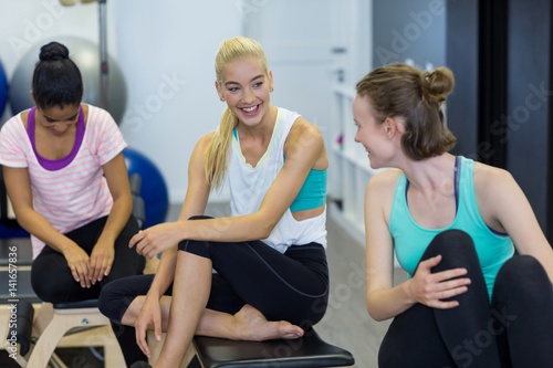 Smiling fit women interacting with each other