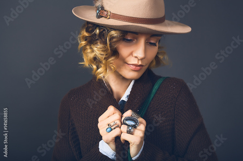 Fashion lifestyle portrait of sensual beautiful young woman in hat, natural beauty face, skin care, bright sexy make up, traveling mood,curly hair,stylish look,red lips,beauty make up