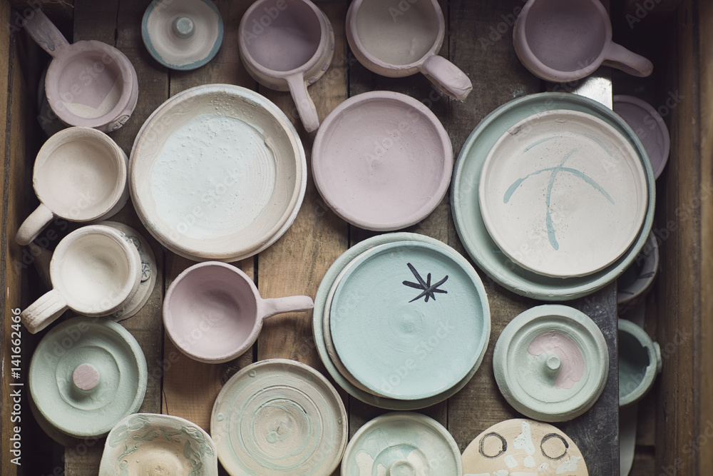 Overhead view of various ceramics on table in workshop Overhead view of various ceramics on table in workshop