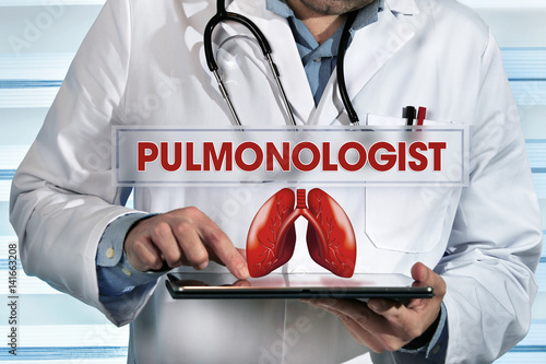 pulmonologist working with tablet in hands in the lab with text pulmonologist / pneumologist holding tablet pc in the clinic with text pulmonologist  photo