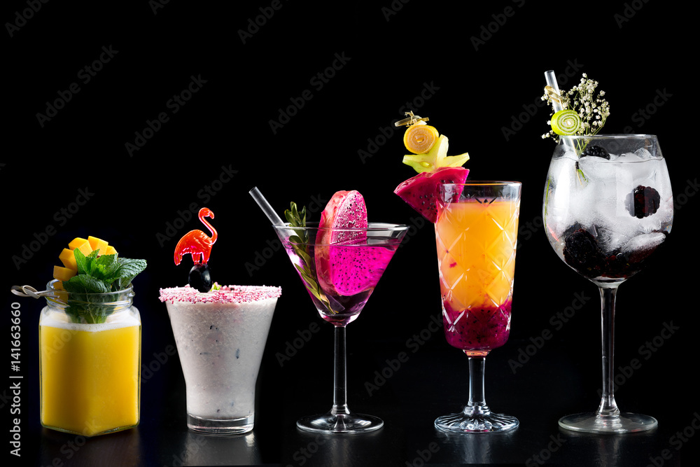 modern rustic selection of cocktails drinks alcohol at bar counter with defocused background various colours glass