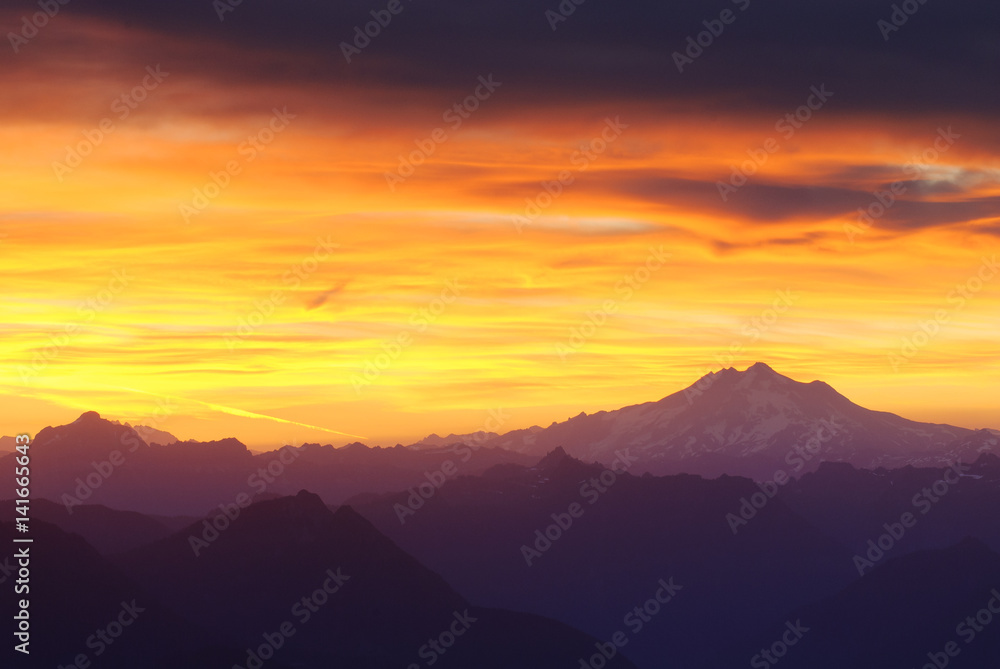 Silhouette mountains against dramatic sky during sunset Silhouette mountains against dramatic sky during sunset