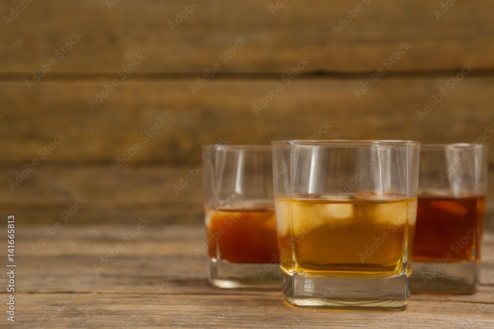 Three glasses of whiskey with ice cube Three glasses of whiskey with ice cube