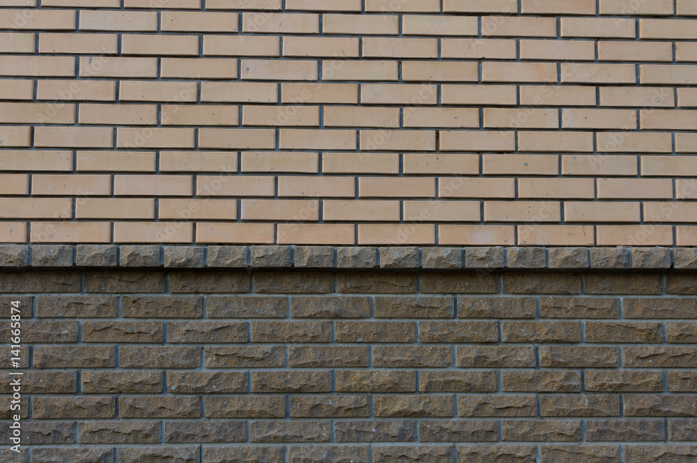 Obraz premium Wall composed of two types of brick yellow and Brown