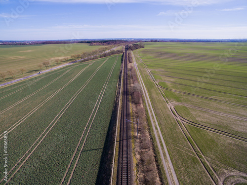 aerial view of railroad tracks in the countryside with agricultural fields - germany