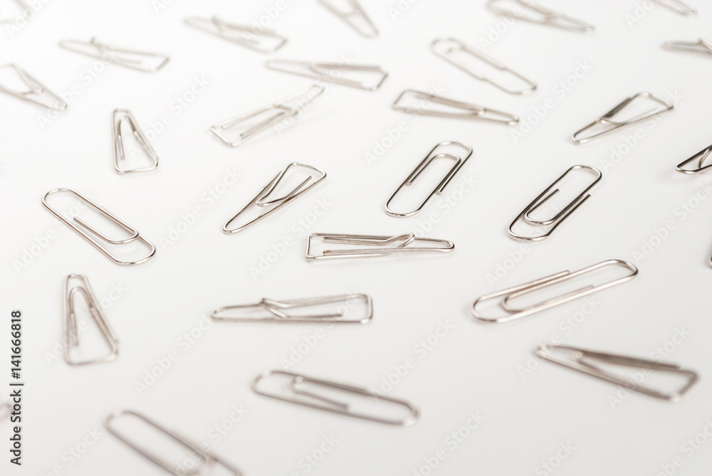 many paper clips on a white background many paper clips on a white background