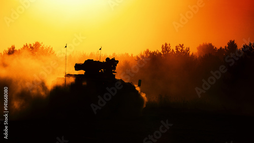 ARMORED INFANTRY FIGHTING VEHICLE - military vehicle in the forest at sunset photo