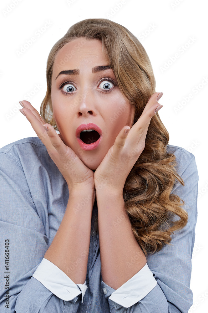 Shocked young woman with opened mouth touching her cheeks isolated on white Shocked young woman with opened mouth touching her cheeks isolated on white